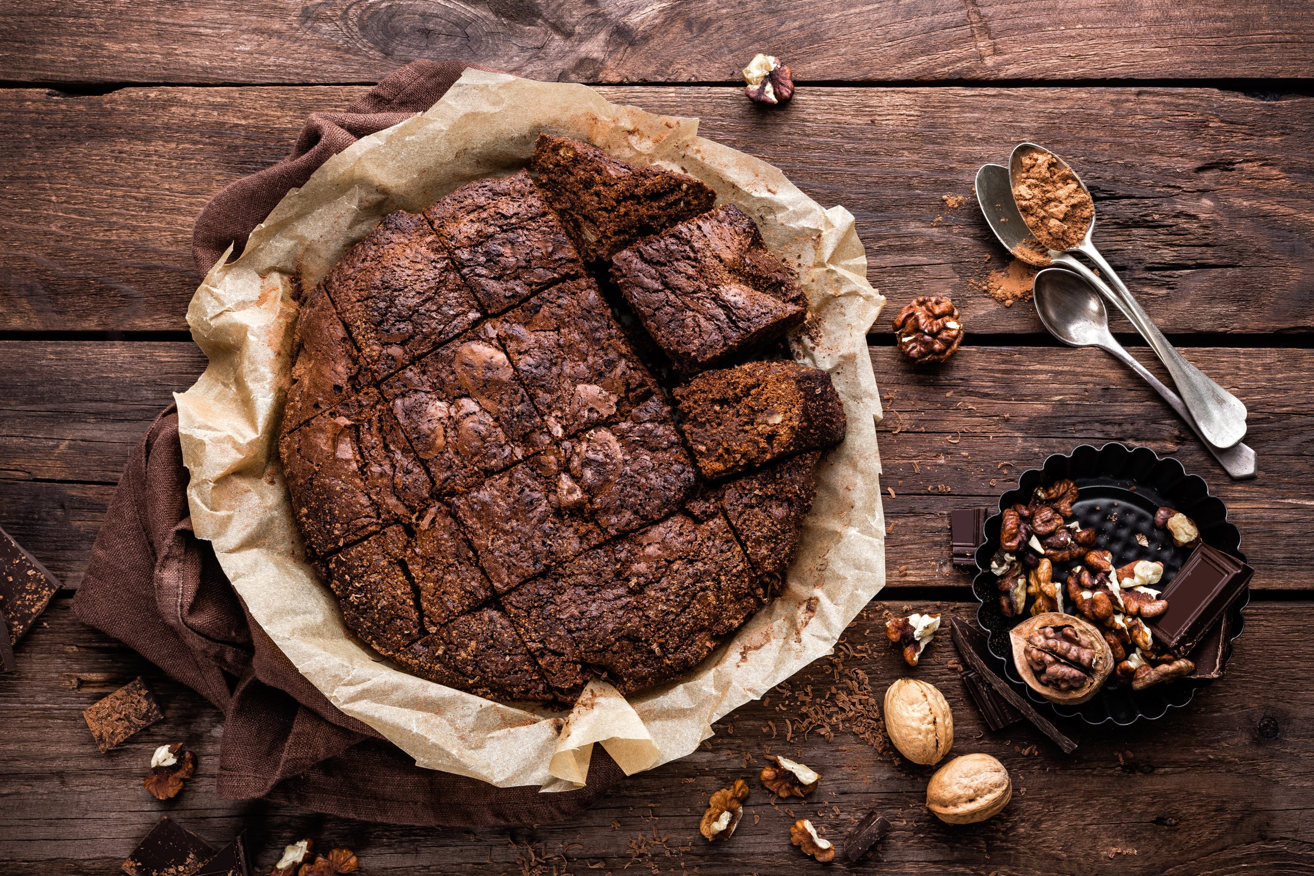 homemade chocolate brownie on dark wooden background, top view